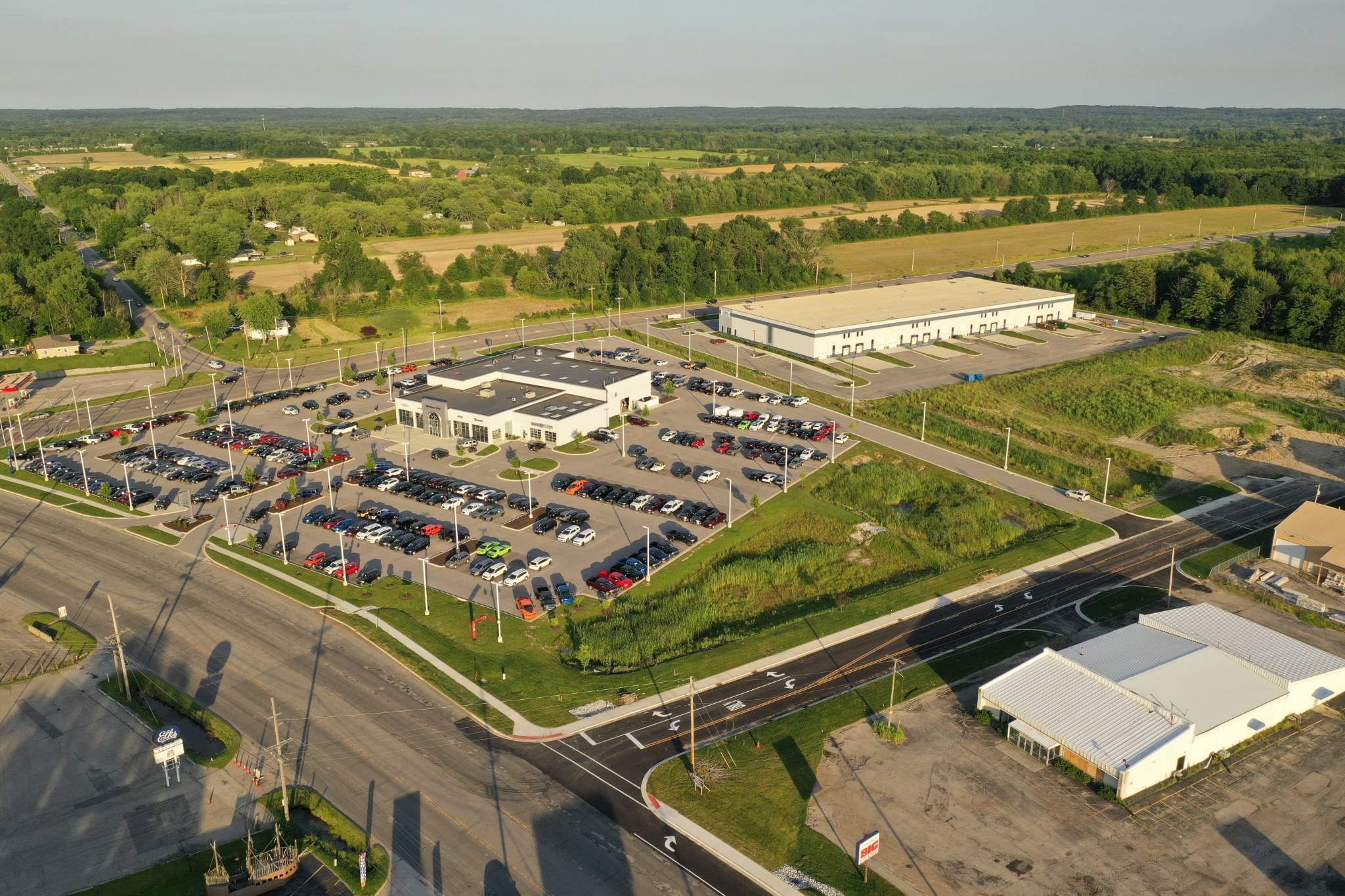 Dealership, Haskell building, and Ameriplex Drive in evening light